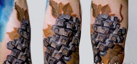 手臂彩色立体的键盘键和叶子纹身图案