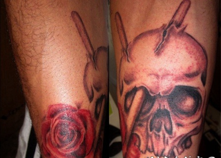 手臂彩色的骷髅与鼓棒玫瑰纹身图案