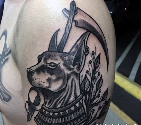 手臂黑色的圣狗与植物纹身图案