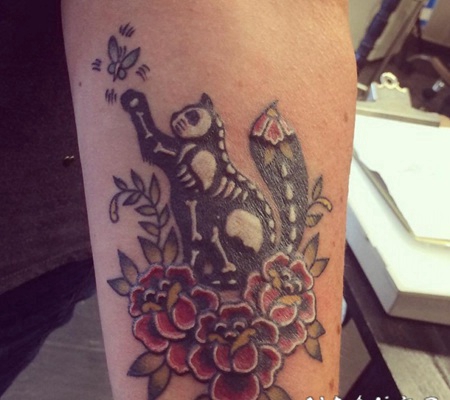 手臂彩色猫与骨骼和花朵纹身图案