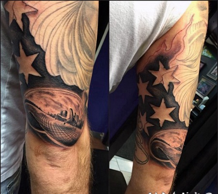 手臂黑色美国国旗与城市景观纹身图案