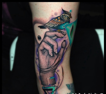 手臂抽象风格的彩色手与鸟和符号纹身图案