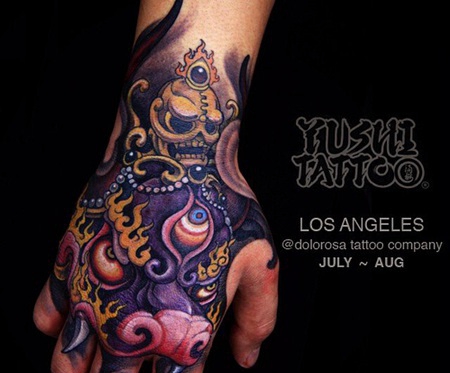 手背上唐狮和骷髅头纹身图案