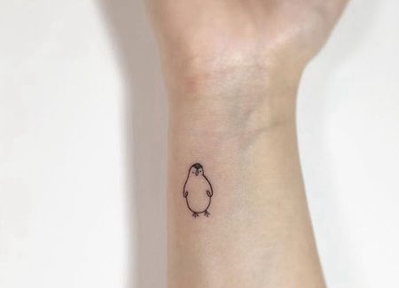 手臂侧面简单的小企鹅轮廓纹身