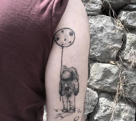宇航员拿着气球站在月球上的纹身