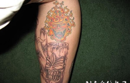 小臂笑面蜡烛纹身图案