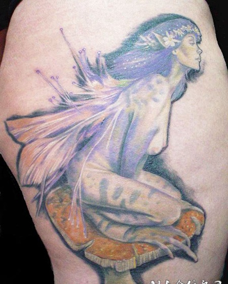 大臂上踩着蘑菇的美女纹身图案