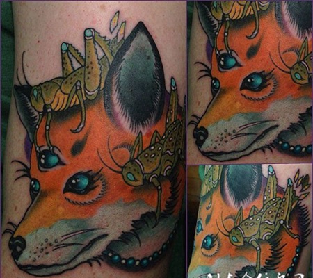大臂上的三眼狐狸头纹身图案