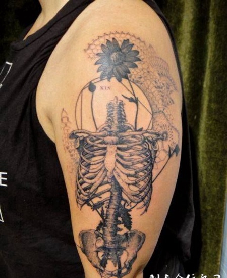 胳膊上的一个躯干骷髅纹身图案