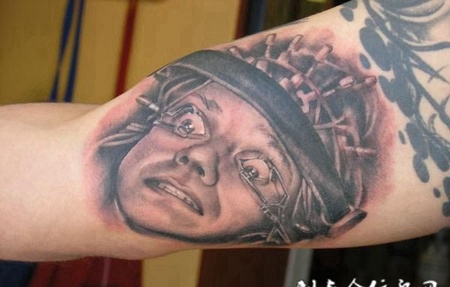 大臂内侧的人头纹身图案
