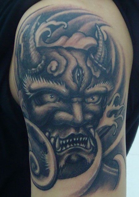 大臂上的鬼头纹身图案