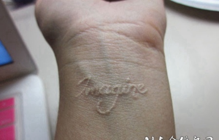 手腕处小巧的英文图案鸽子血纹身