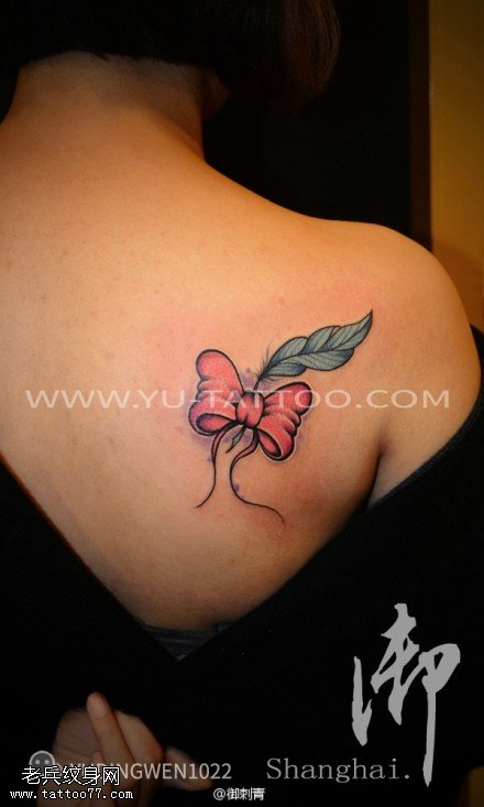 女性背部彩色蝴蝶结羽毛纹身图案