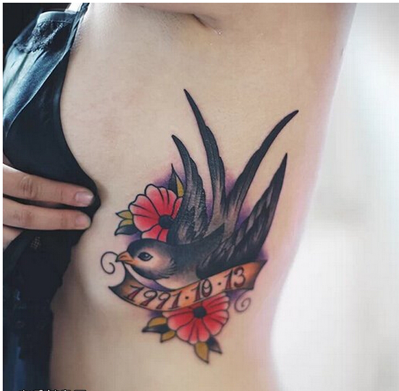 女性侧腰漂亮好看的彩色燕子花纹身图图片