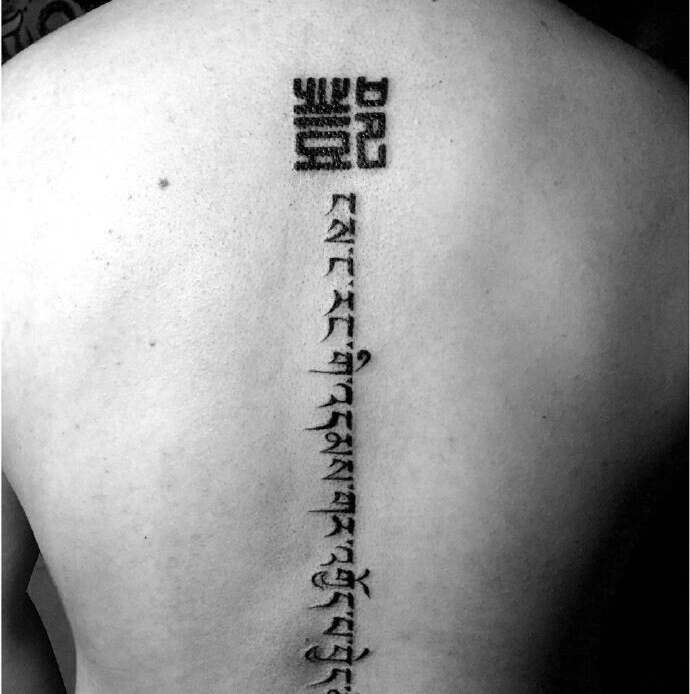 落在脊椎部的时尚梵文纹身图片
