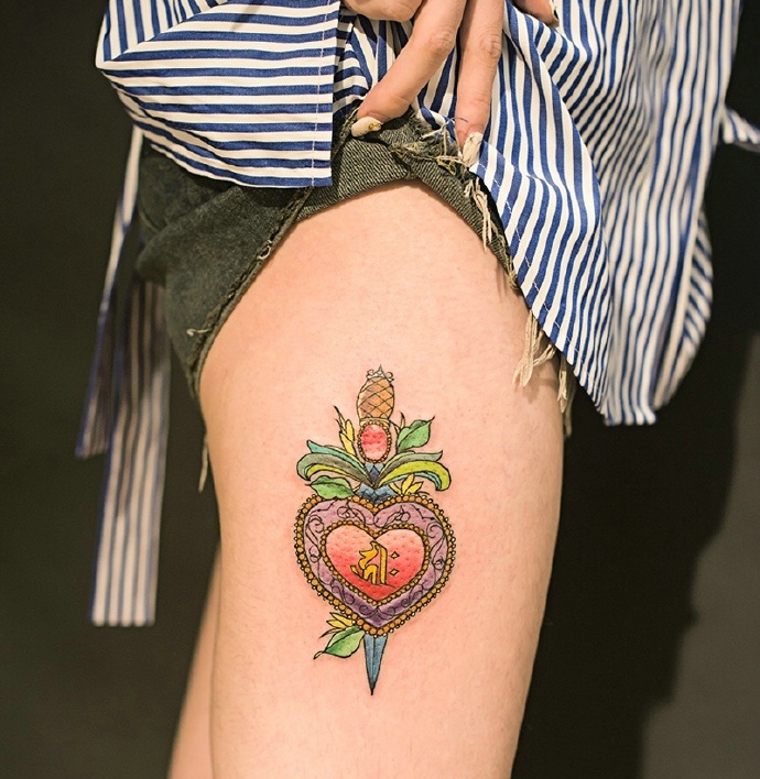 大腿外侧匕首穿刺爱心的个性纹身图案