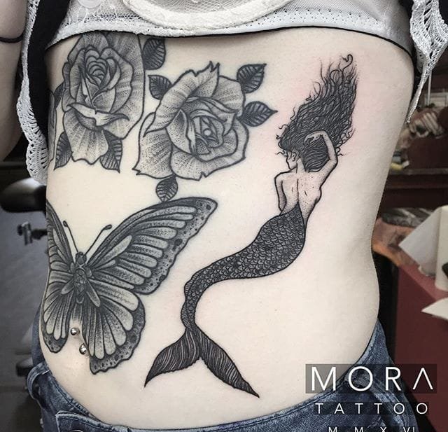 大臂上云朵下雨到茶杯的纹身图片