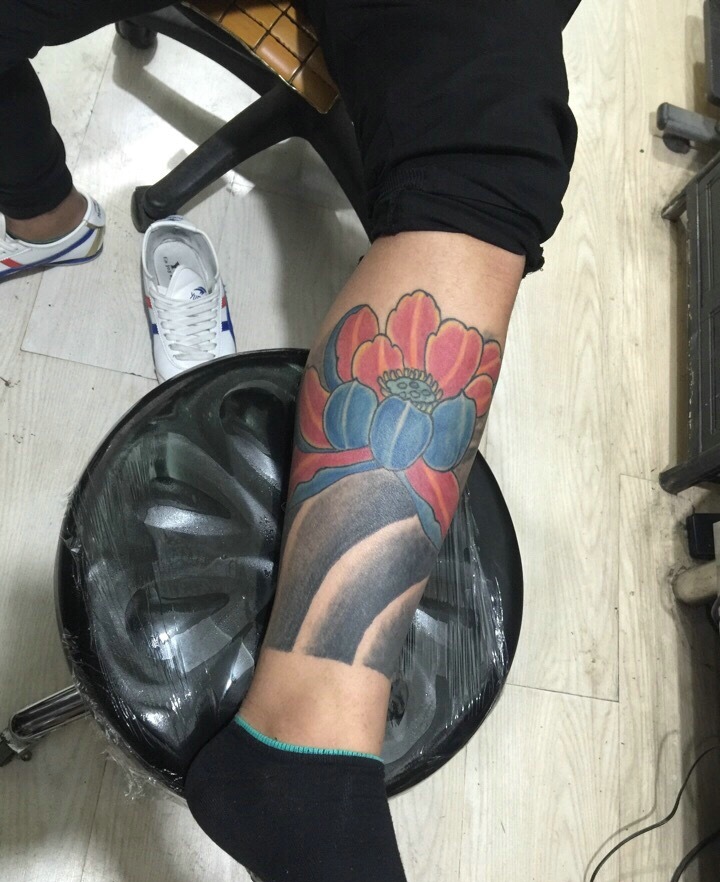 包小腿彩色莲花纹身图案很抢眼