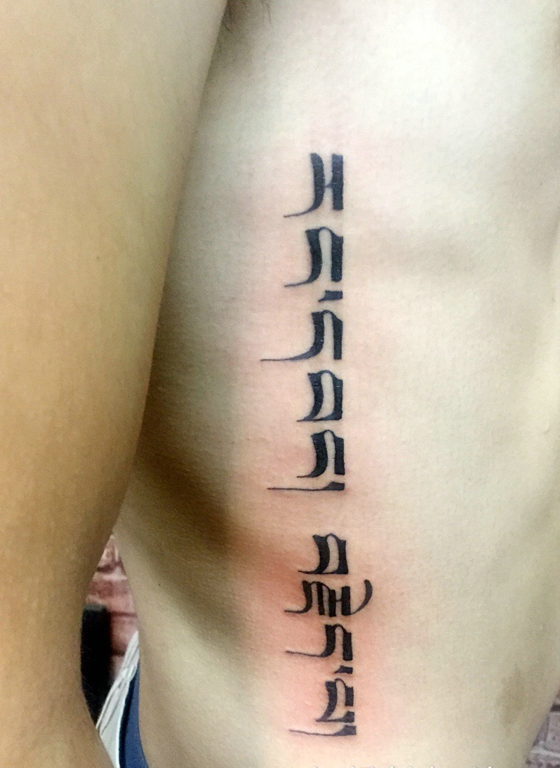 侧腰部简单帅气的梵文纹身刺青