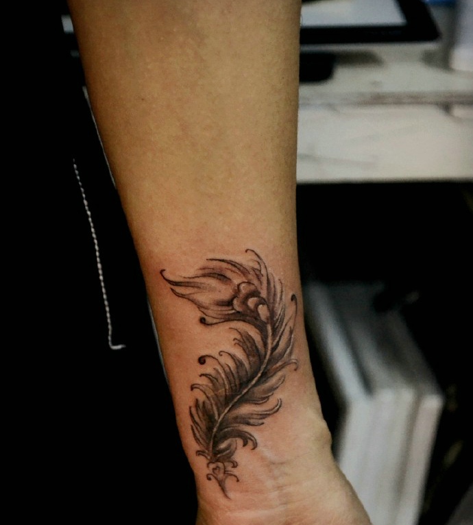 手臂一片黑灰羽毛纹身图案