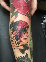 花臂膀上的红色和黄色玫瑰花里的女子肖像纹身