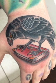 手背彩色卡通乌鸦与书纹身图案