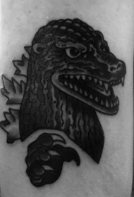 手臂简单的卡通黑色小哥斯拉头纹身图案