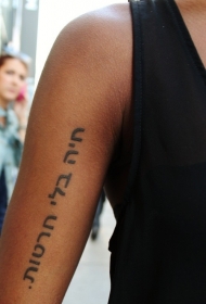 大臂整齐的黑色阿拉伯字母纹身图案