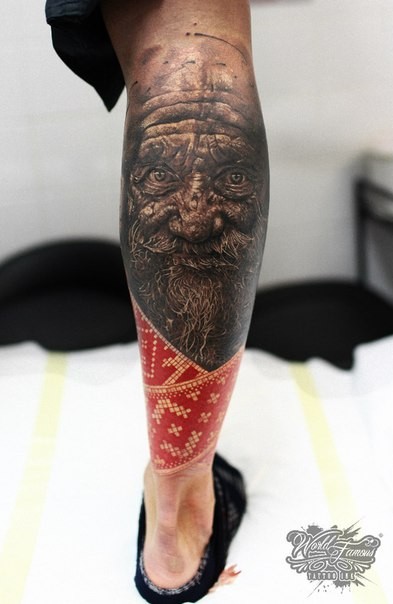 小腿彩色令人毛骨悚然的老人脸纹身图案