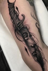纹在手臂上的黑灰冷兵器匕首纹身图