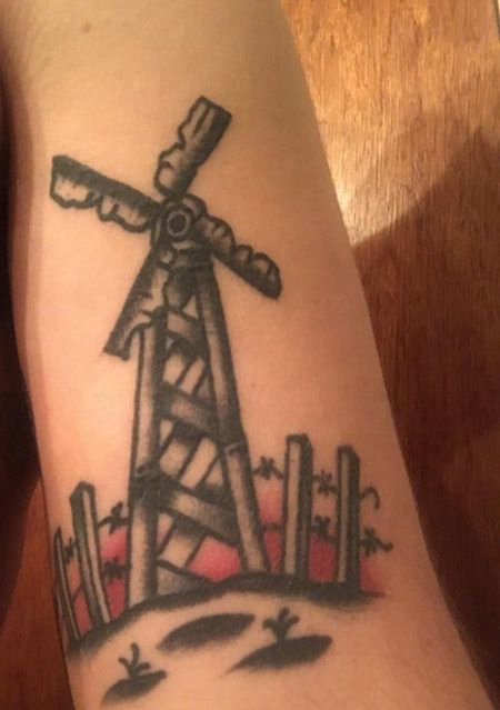 大臂残破的风车纹身图案