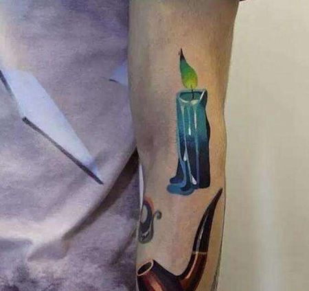 手臂烟斗和蜡烛纹身图案
