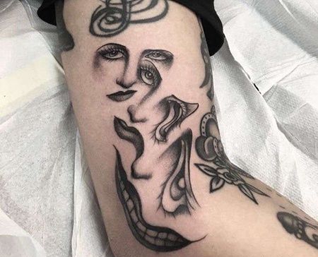 大臂眼睛嘴巴纹身图案