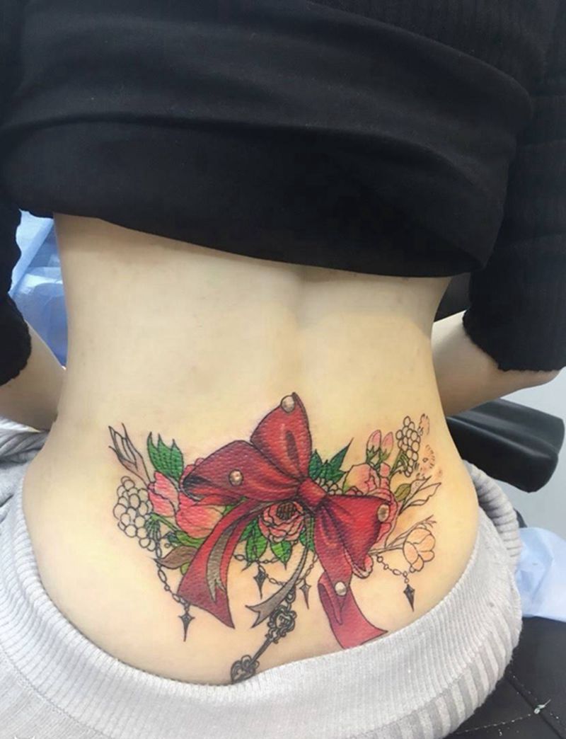 原创蝴蝶结未完纹身图片_成品腰部清新原创植物静物纹身图案