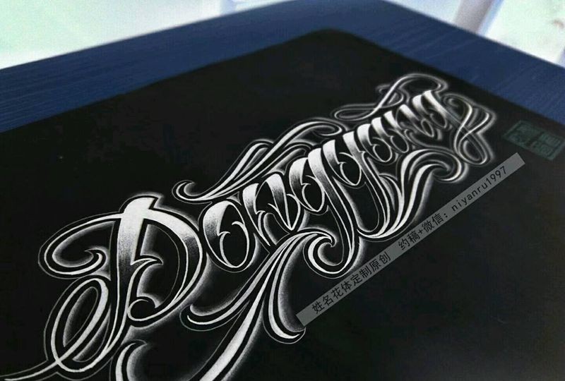 手臂奇卡诺花体纹身图片