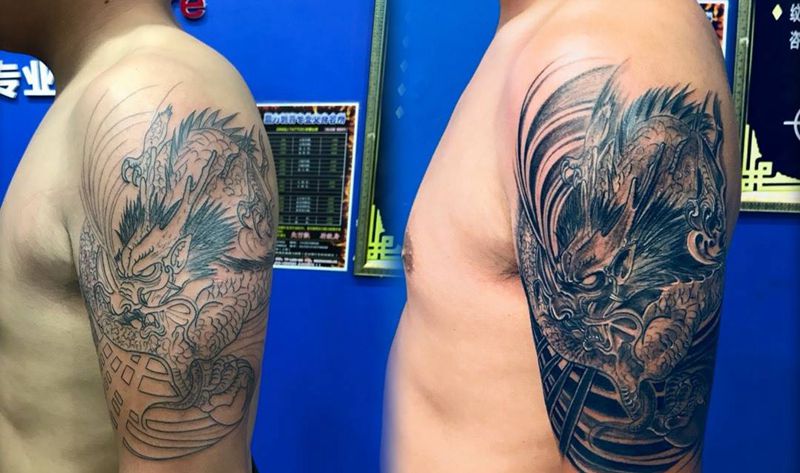 大臂龙头纹身图片