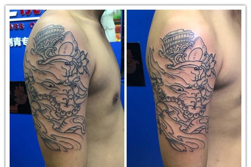 大臂象神线条纹身图片