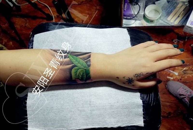 美女手臂荷花浪花完成纹身图片