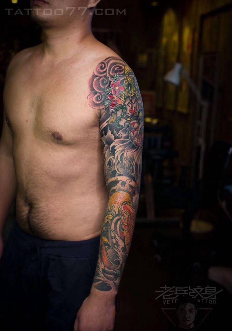 传统象神鲤鱼花臂纹身作品纹身图片_成品手臂传统动物纹身图案