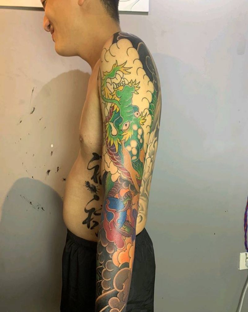 青龙牡丹臂纹身图片_手臂纹身图案