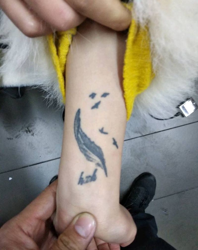 羽毛遮盖纹身图片