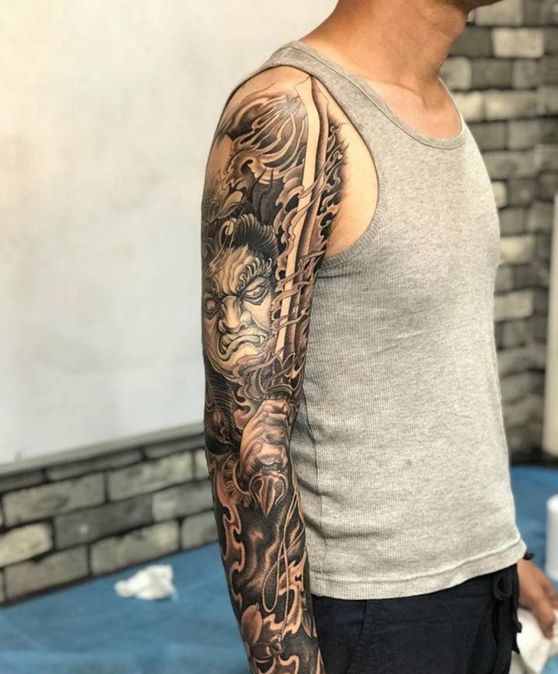 花臂不动冥王纹身图片_手臂纹身图案