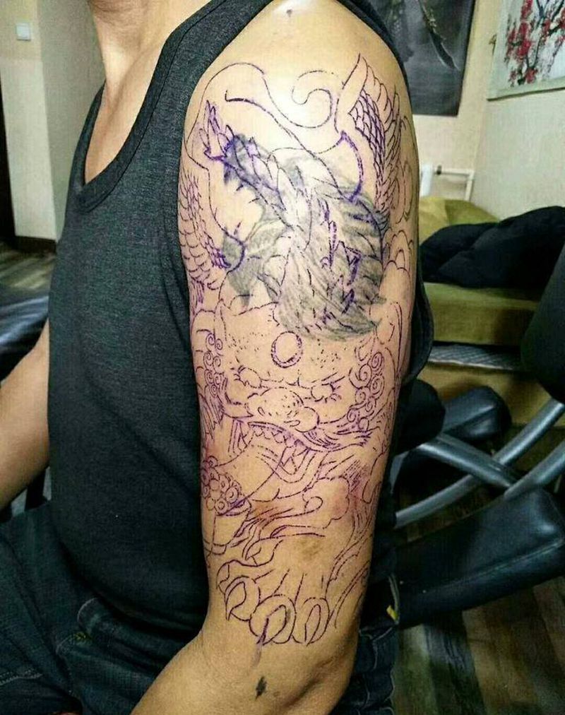 招财貔貅遮盖狼头。纹身图片