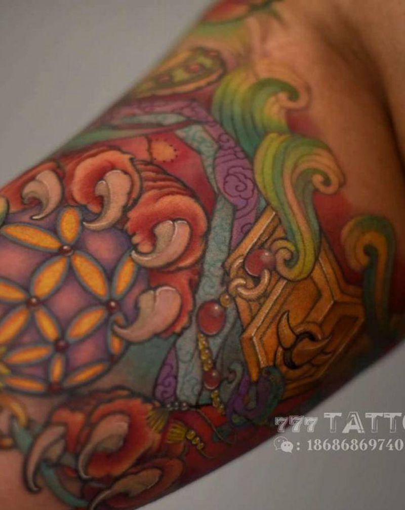 唐狮子内壁绣球纹身图片_手臂新传统彩色唐狮子纹身图案