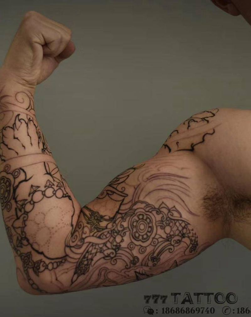 唐狮子花臂一根纹身图片_手臂新传统唐狮子纹身图案