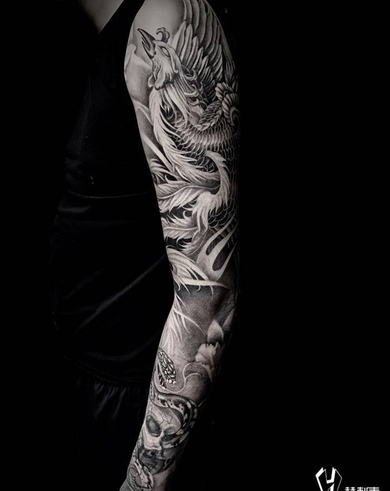 重生与希望纹身图片_手臂凤凰蛇骷髅纹身图案